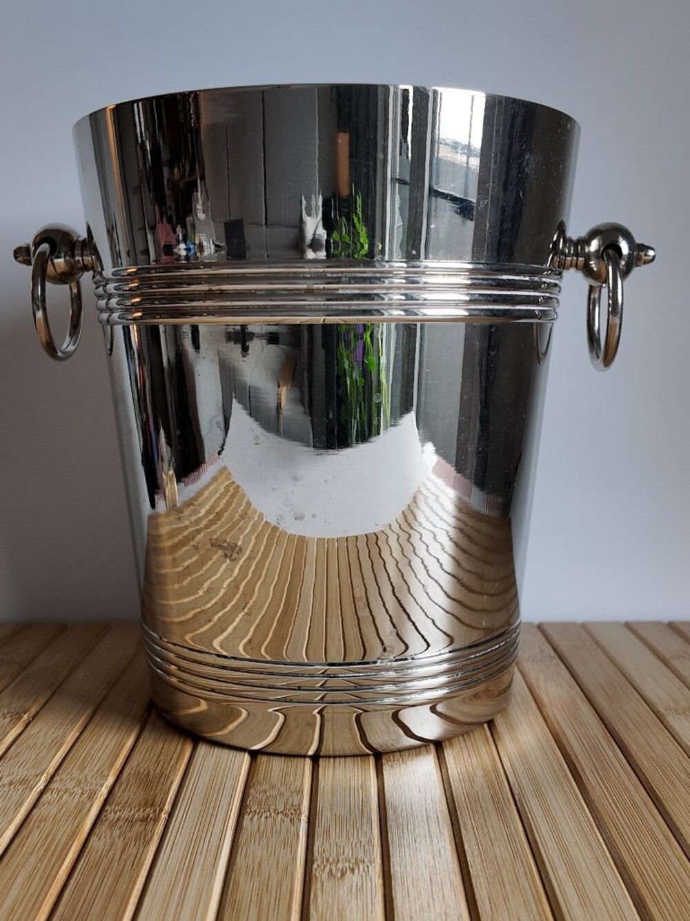 Vintage silver-plated ice bucket features a high-polish finish over brass base